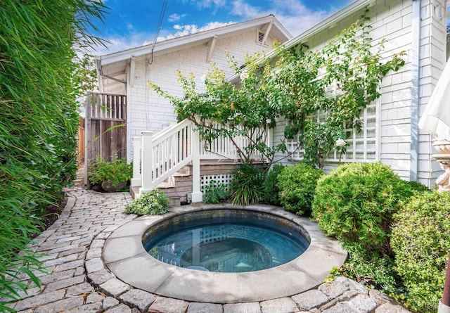 view of pool with an in ground hot tub