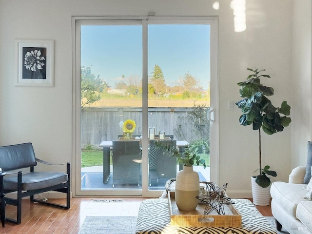 doorway with hardwood / wood-style flooring and a wealth of natural light