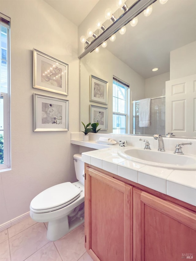 bathroom with vanity, a shower with shower door, tile patterned floors, and toilet