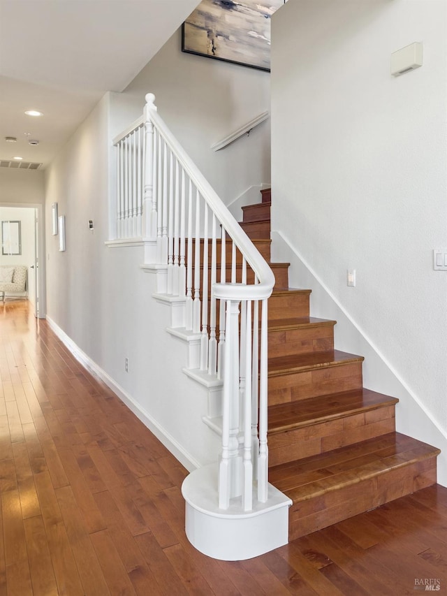 stairway featuring hardwood / wood-style floors