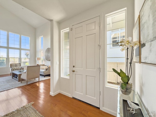 foyer featuring vaulted ceiling and light wood-type flooring