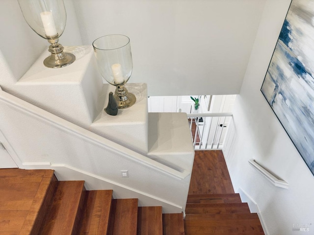 stairway featuring wood-type flooring