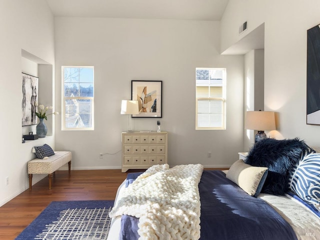 bedroom with dark hardwood / wood-style floors