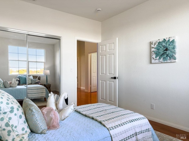 bedroom featuring wood-type flooring and a closet