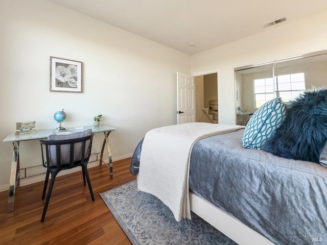 bedroom with dark hardwood / wood-style flooring