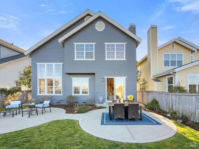 back of property with a patio area and a lawn