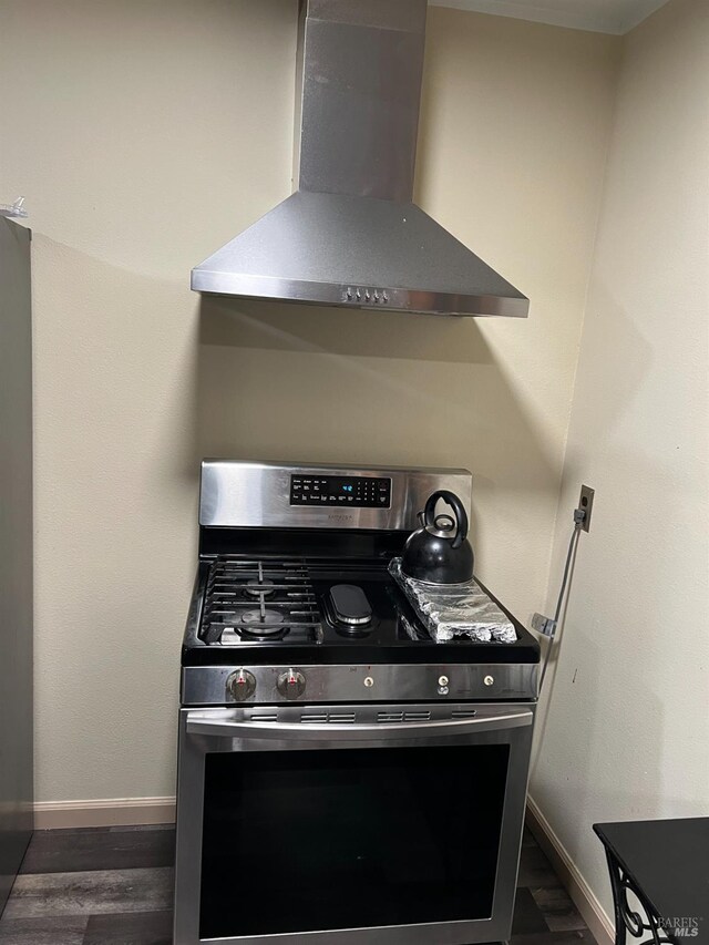 kitchen featuring stainless steel gas range oven and wall chimney range hood