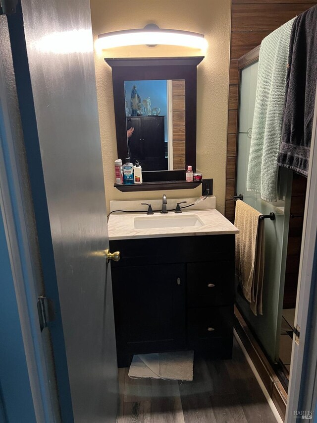 bathroom with vanity and wood-type flooring