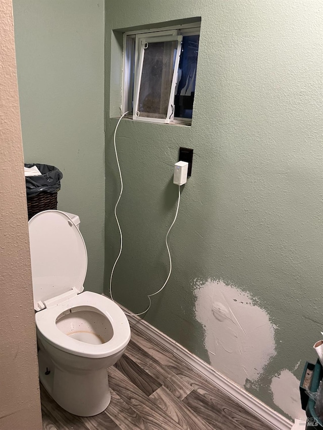 bathroom featuring toilet and hardwood / wood-style floors