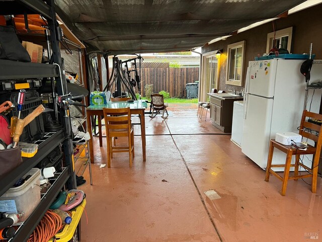 basement featuring white refrigerator