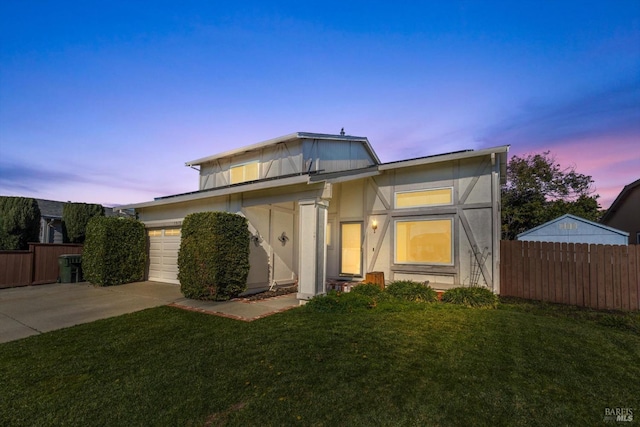 view of front of home featuring a garage, central AC unit, and a lawn