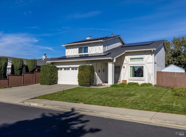 view of front facade with a garage, a front yard, and solar panels