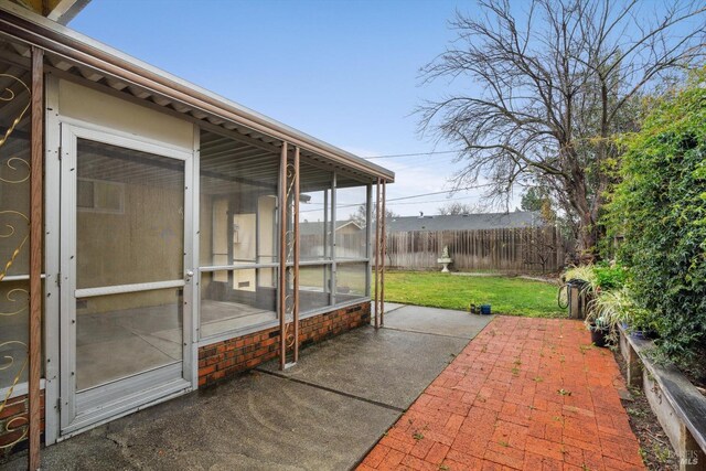 view of patio / terrace featuring a sunroom