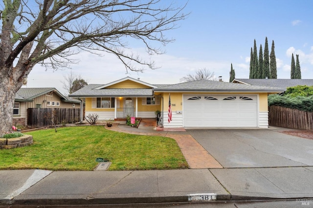 ranch-style house featuring a garage and a front lawn