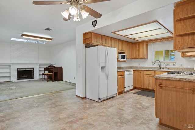 kitchen with a sink, visible vents, white appliances, and open shelves