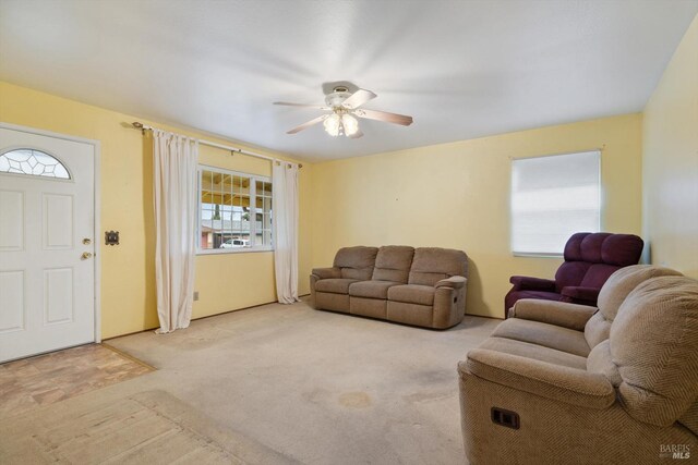 living room featuring light carpet and ceiling fan