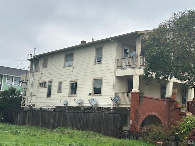 rear view of property with a balcony