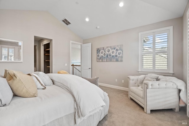 bedroom with lofted ceiling and light colored carpet