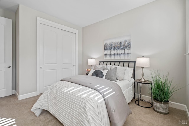 bedroom with a closet and light carpet