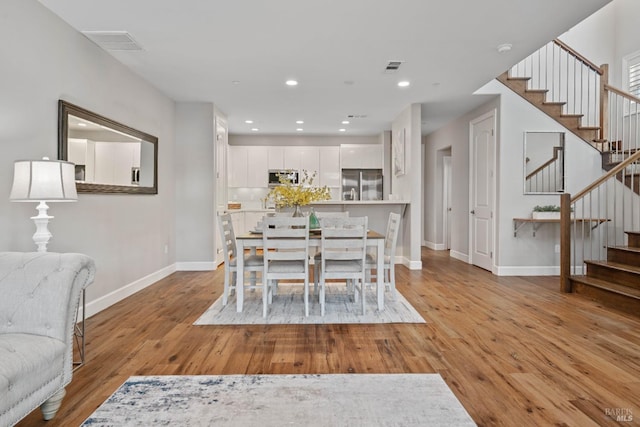 dining space featuring light hardwood / wood-style floors