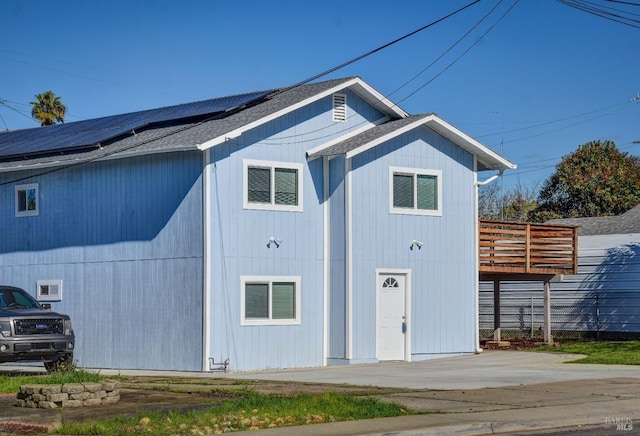 exterior space featuring solar panels and a deck