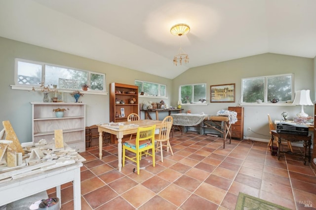 tiled dining space with vaulted ceiling