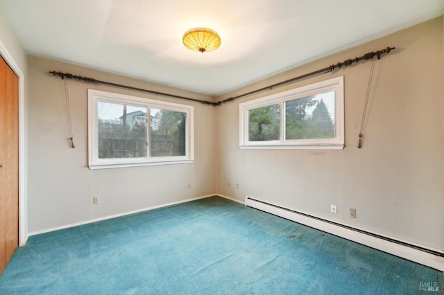 spare room featuring carpet and baseboard heating