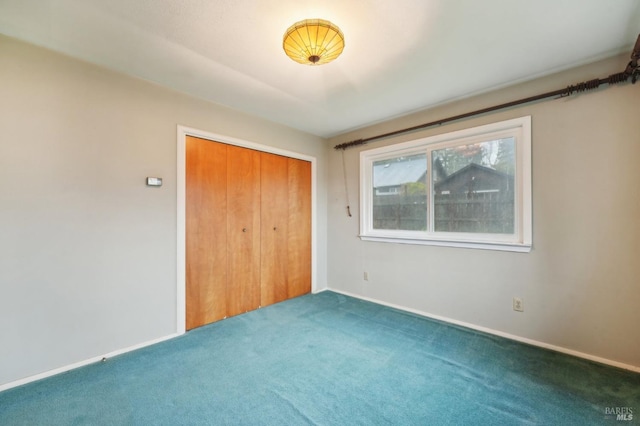 unfurnished bedroom featuring carpet floors and a closet