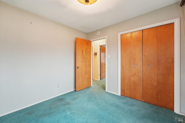 unfurnished bedroom with light colored carpet and a closet