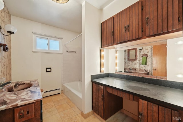 bathroom with tiled shower / bath combo, a baseboard radiator, vanity, and tile patterned floors