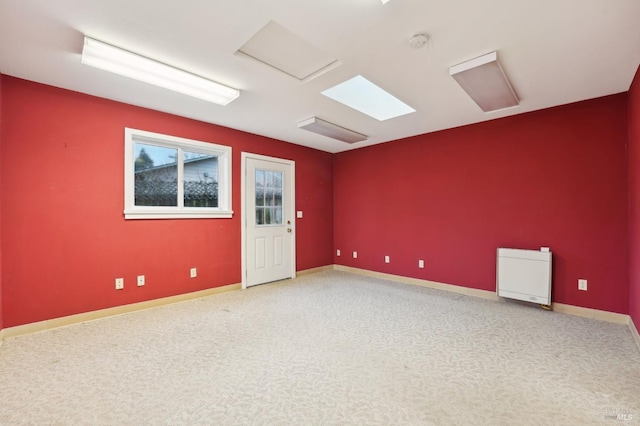 unfurnished room featuring carpet floors and heating unit