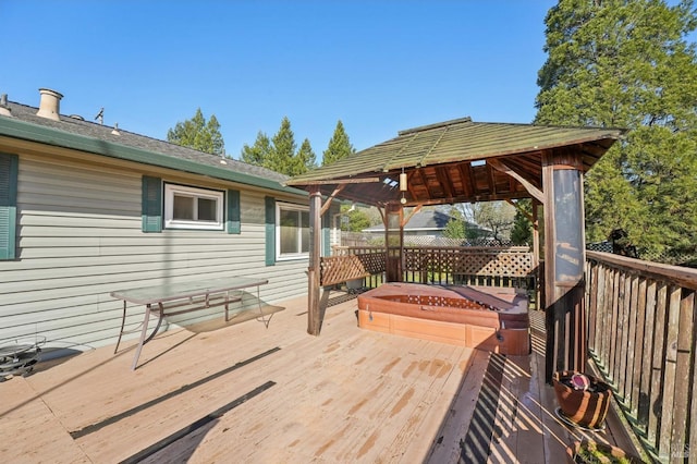 wooden terrace with a gazebo and a covered hot tub