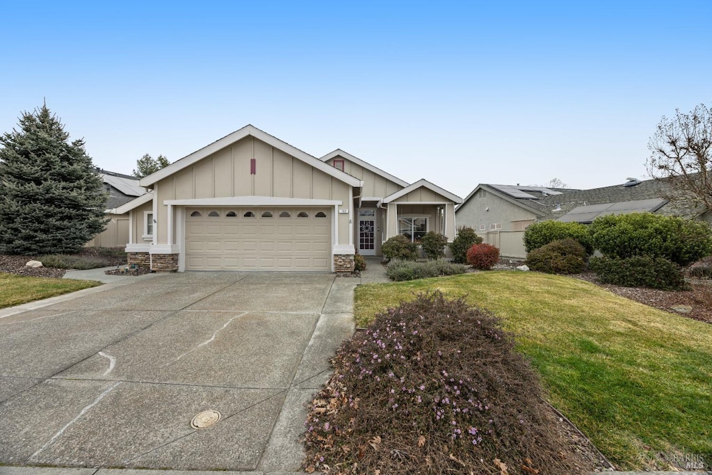 single story home featuring a garage and a front yard