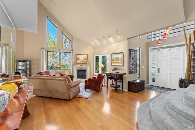 3057 Saint Helena Hwy N, Saint Helena, CA 94574 - living room featuring light wood-style floors, track lighting, high vaulted ceiling, and a glass covered fireplace