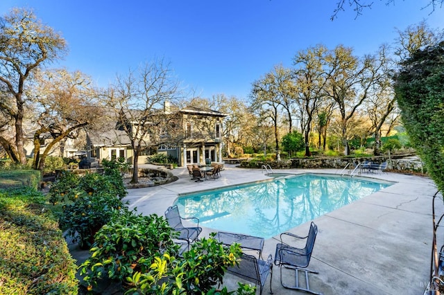 view of swimming pool with a patio