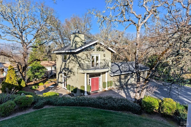 3057 Saint Helena Hwy N, Saint Helena, CA 94574 - view of side of property featuring stucco siding, a balcony, a lawn, a chimney, and a patio area