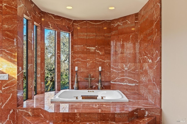 bathroom featuring a relaxing tiled tub