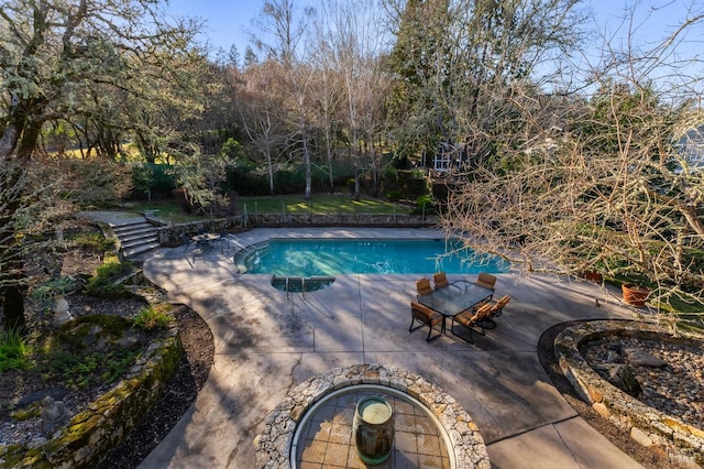 view of pool with a jacuzzi and a patio