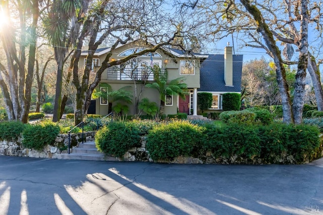 3057 Saint Helena Hwy N, Saint Helena, CA 94574 - view of front of house with a balcony, a chimney, and stucco siding