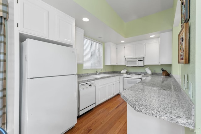 3057 Saint Helena Hwy N, Saint Helena, CA 94574 - kitchen featuring white appliances, white cabinetry, light wood finished floors, a sink, and a peninsula