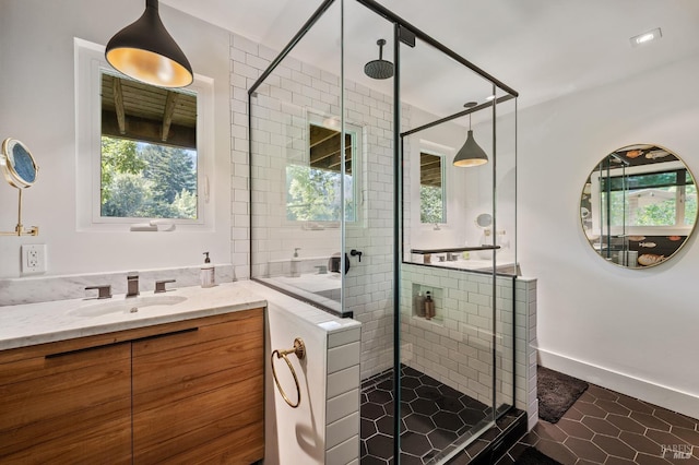 bathroom featuring vanity, an enclosed shower, and tile patterned flooring