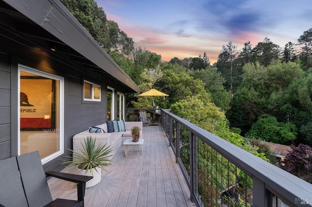 deck at dusk with an outdoor living space