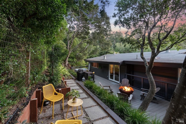 exterior space with a deck and a fire pit