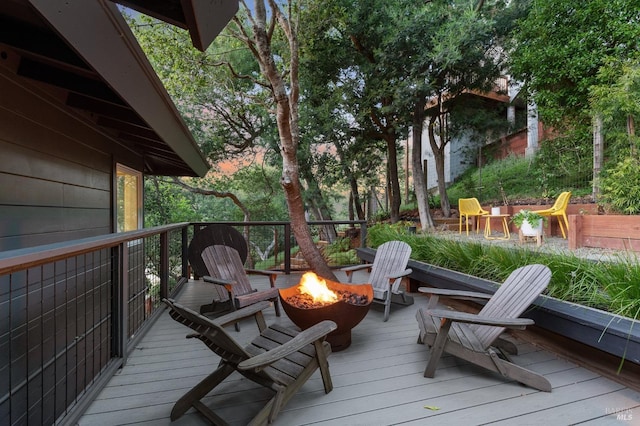 wooden terrace with a fire pit