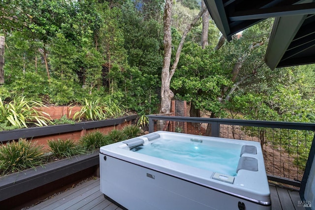 wooden deck featuring a hot tub