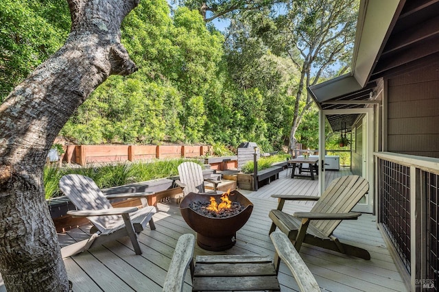 deck featuring an outdoor fire pit