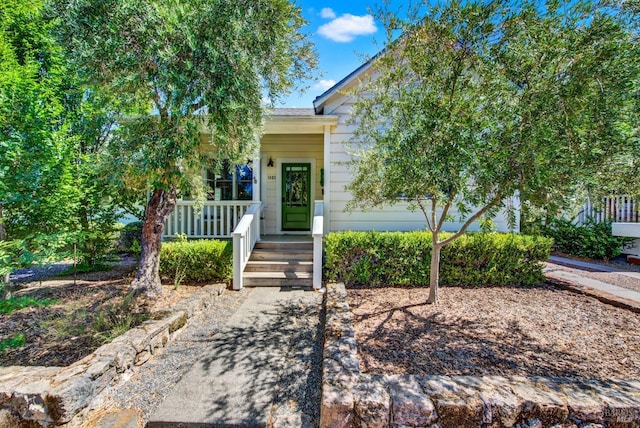 obstructed view of property featuring covered porch