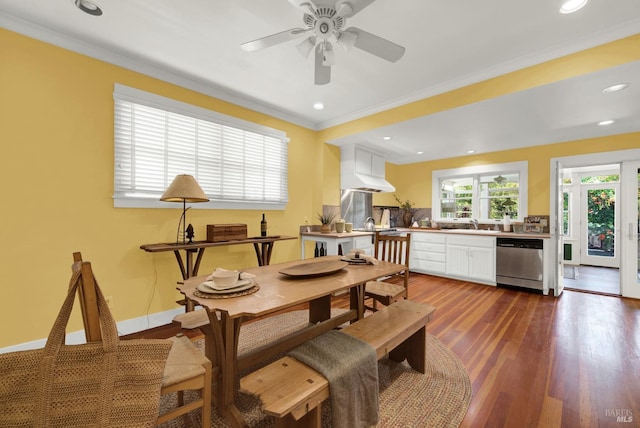 dining space with crown molding, dark hardwood / wood-style floors, and ceiling fan