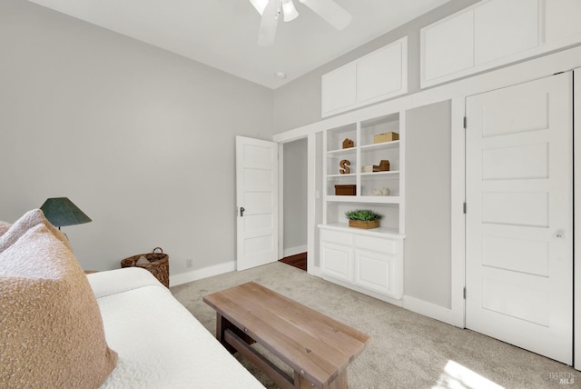 carpeted living room with ceiling fan