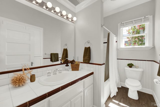 full bathroom featuring hardwood / wood-style flooring, shower / bath combo, vanity, ornamental molding, and toilet